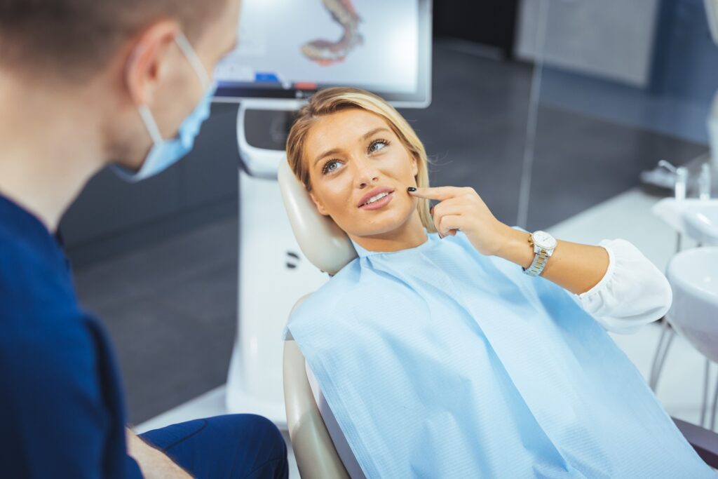 Woman asking orthodontist question at appointment